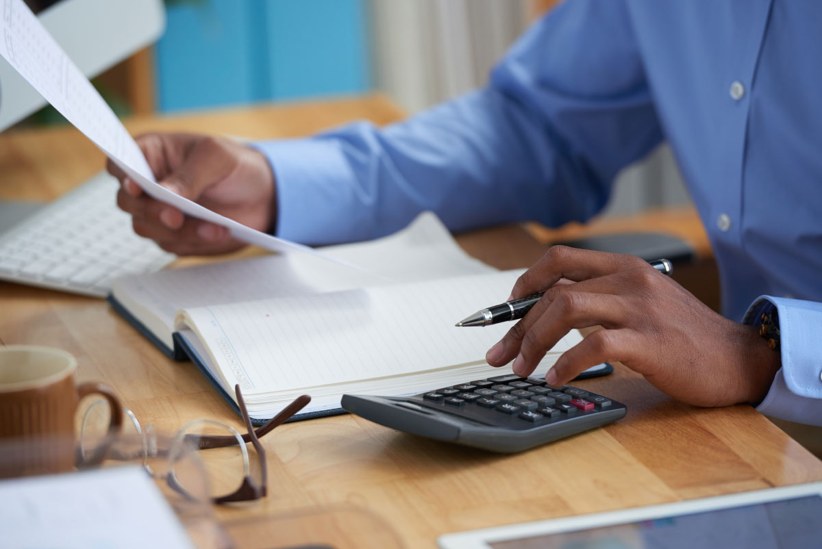photo of a man doing calculations with collection agencies
