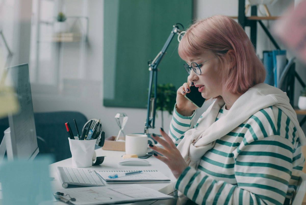 photo of a woman speaking with a collections agent on the phone